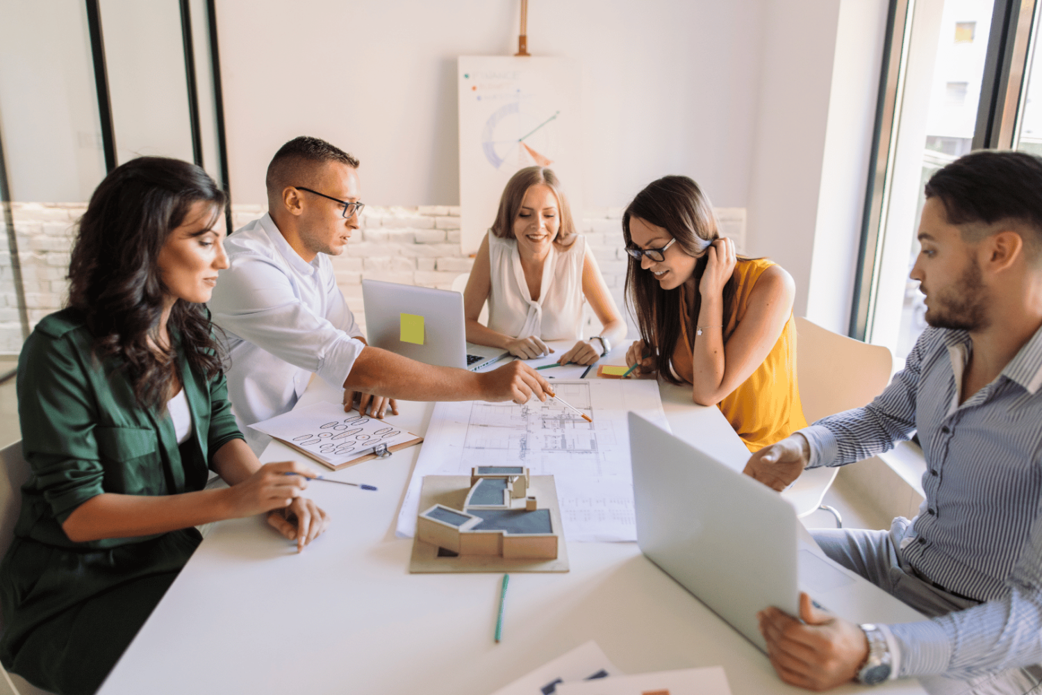 A group of coworkers sat around a table discussing a project.